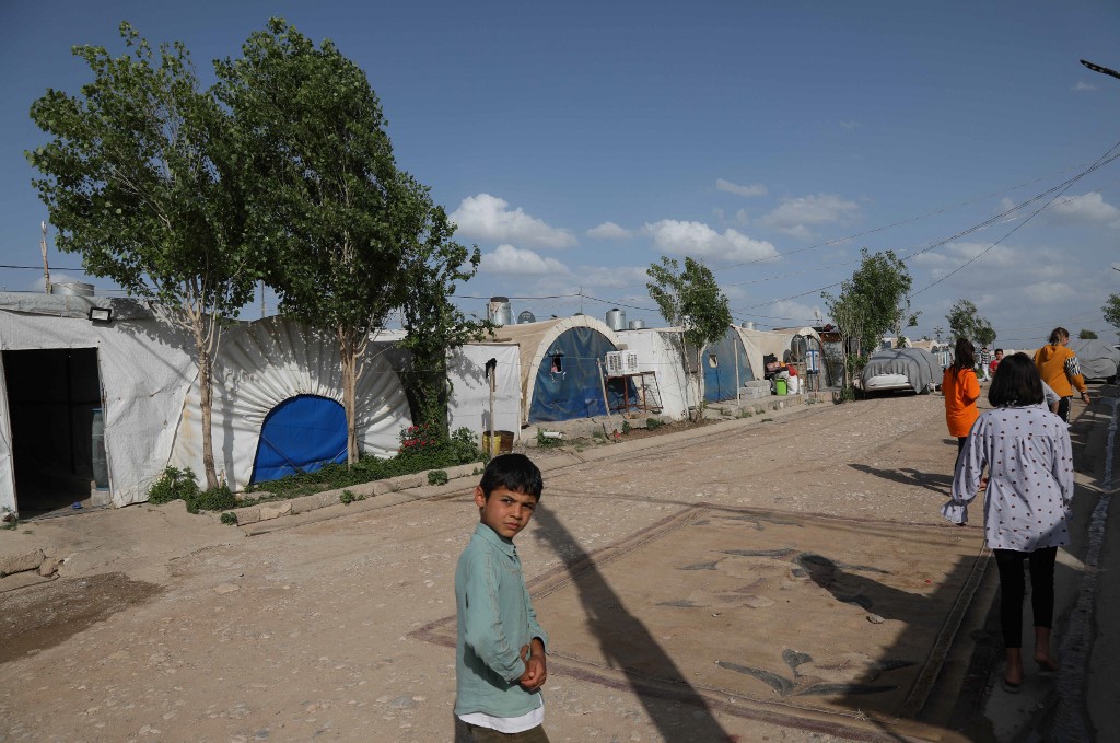 Displaced Yazidis stand by their tents at the Chamishko camp for internally displaced persons (IDP) in the city of Zakho in the north of Iraq's autonomous Kurdish region on May 5, 2022. (Photo: Safin Hamed/AFP)