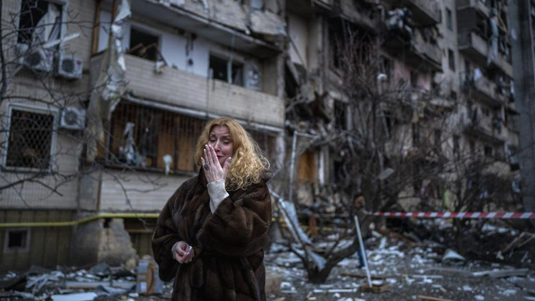 Natali Sevriukova stands next to her destroyed apartment following a rocket attack on Ukraine's capital Kyiv, Feb. 25, 2022. (Photo: Emilio Morenatti/AP)