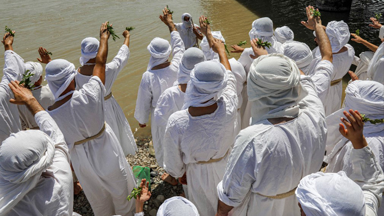 Sabean worshippers, take part in a cleansing ritual known as the "Golden Cleansing", along the banks of the Great Zab river, May 18, 2022. (Photo: Safin Hamed/AFP)