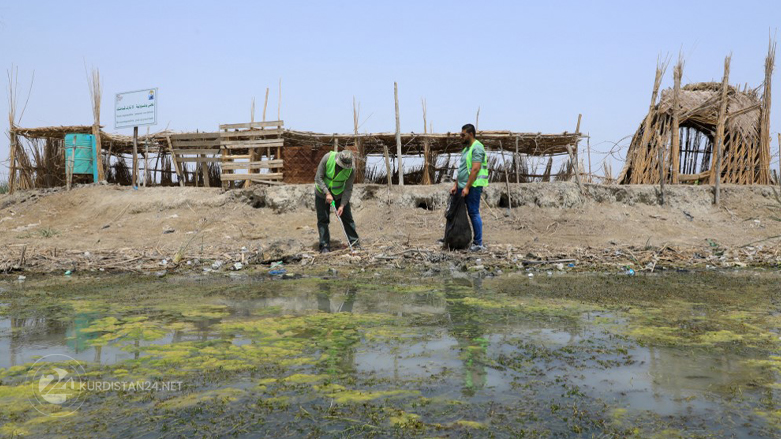 Members of an Iraqi NGO clean up southern Iraq's marshes of Chibayish during an environmental campaign mission in the southern Iraqi province of Dhi Qar, May 19, 2022. (Photo: Asaad Niazi/AFP)