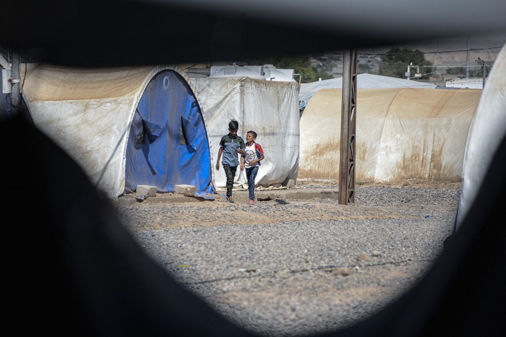 Boys walk near tents at the Jadaa rehabilitation camp for the displaced near the northern Iraqi city of Mosul, on May 11, 2022. (Photo: Zaid Al-Obeidi/AFP)