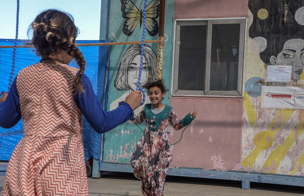 Displaced girls skip at the Jadaa rehabilitation camp for the displaced near the northern Iraqi city of Mosul, on May 11, 2022. (Photo: Zaid Al-Obeidi/AFP)