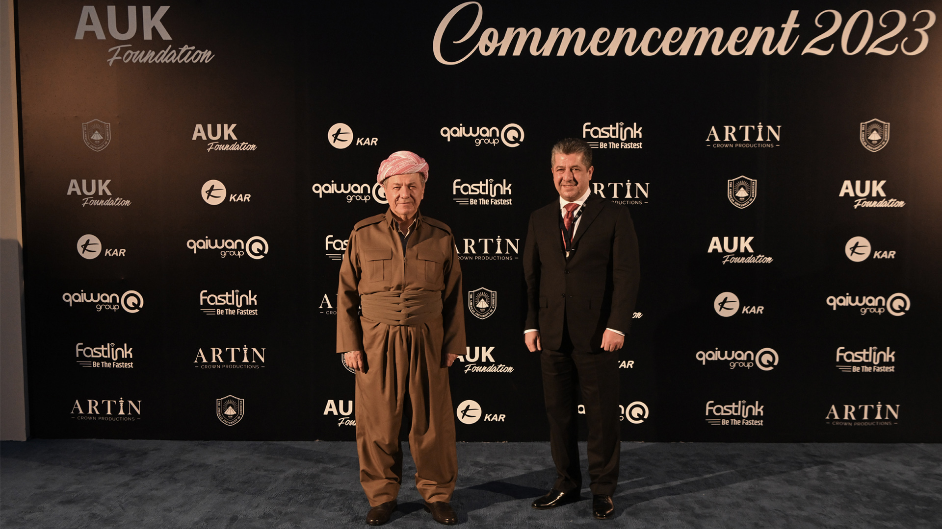 Kurdistan Democratic Party (KDP) President Masoud Barzani (left) posing for a photo with Prime Minister Masrour Barzani at the AUK Class 2023 Commencement in Duhok, May 28, 2023. (Photo: KRG)