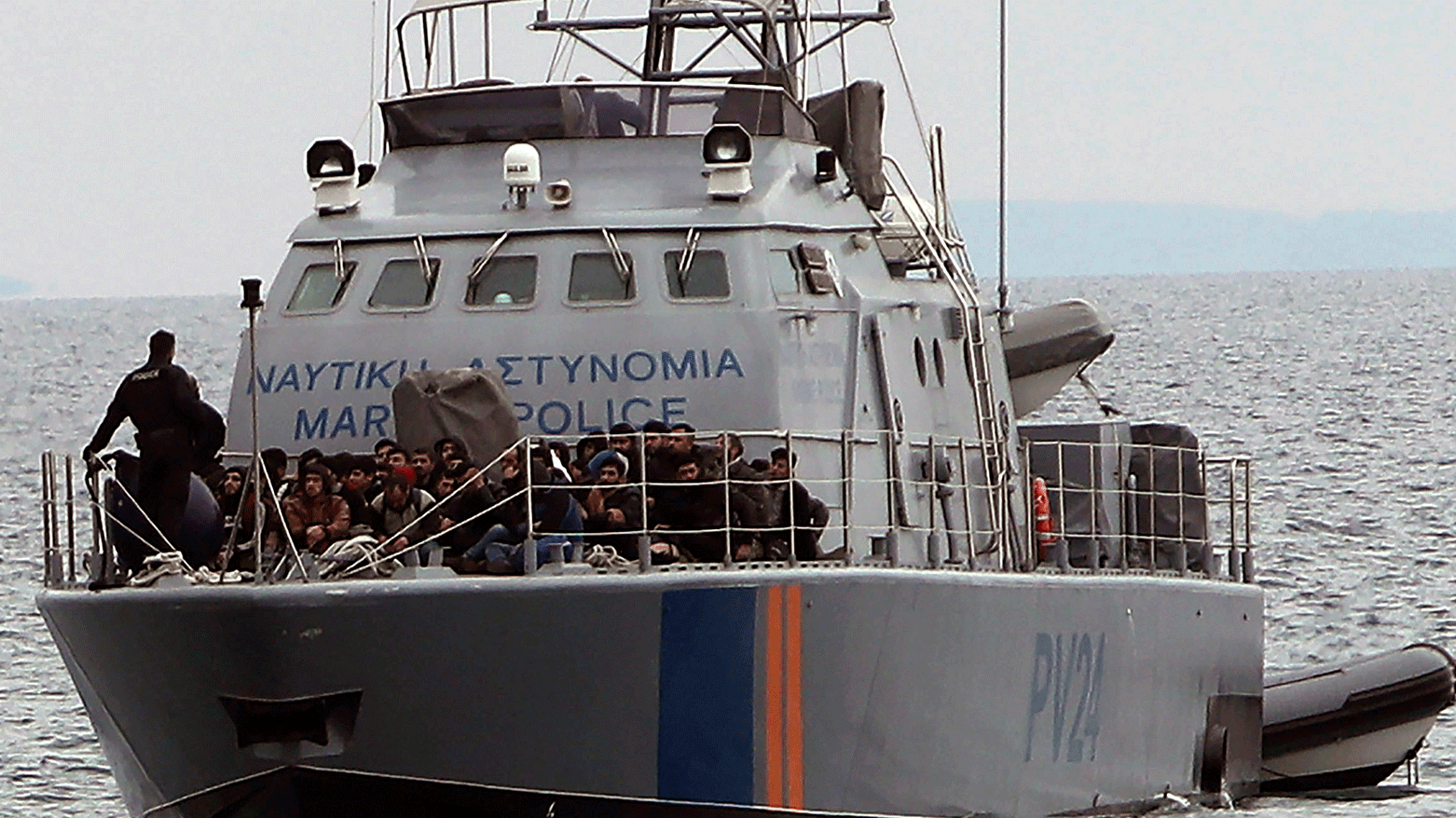 Migrants aboard a Cyprus marine police patrol boat as they're brought to a harbor after being rescued from their own vessel off the Mediterranean island nation's southeastern coast of Protaras, Cyprus, Jan. 14, 2020. (Photo: AP)