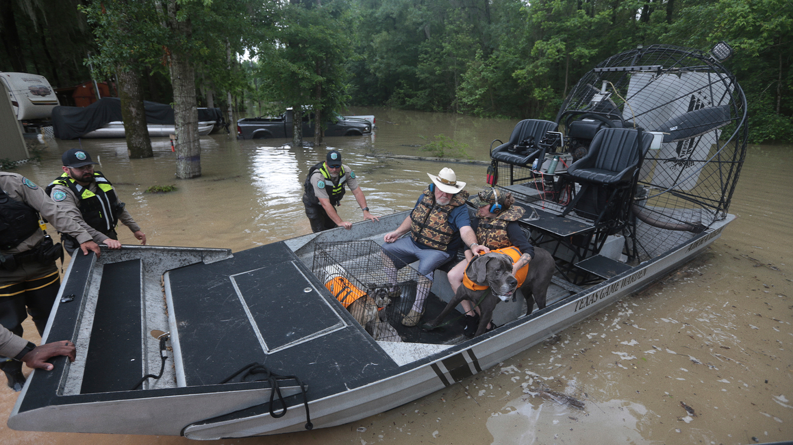 Texas Parks & Wildlife Department game wardens use a boat to rescue residents from floodwaters in Liberty County, Texas, on Saturday, May 4, 2024. (AP Photo/Lekan Oyekanmi)