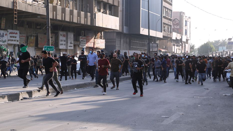 Supporters of Iranian-backed parties in Iraq approach security forces at a protest in Baghdad. (Photo: Social media)