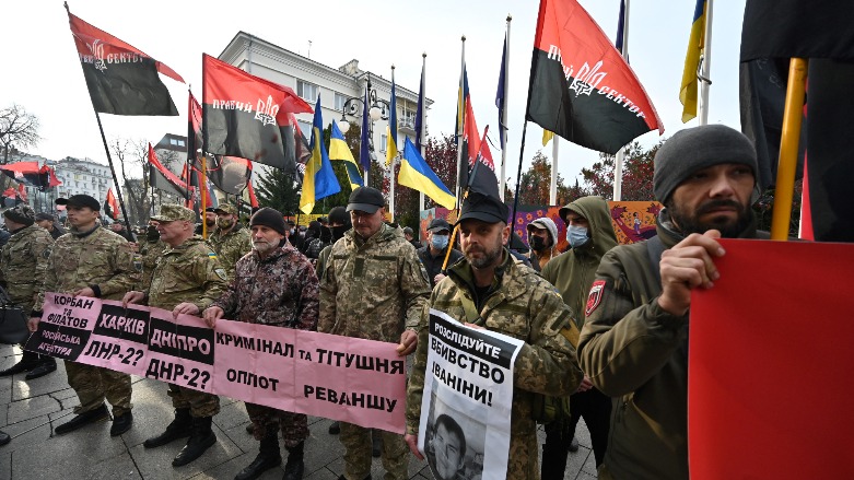 Participants of the war with Russia backed separatists on the east of Ukraine, activists of Right Sector, far-right movement hold placards and flags during their rally called