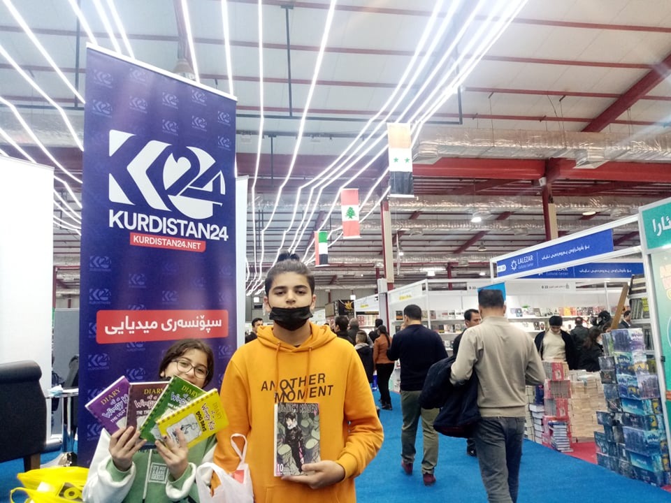 Young readers show off the books they bought at Sulaimani's Third International Book Fair, November 2021. (Photo: Goran Sabah Ghafour)