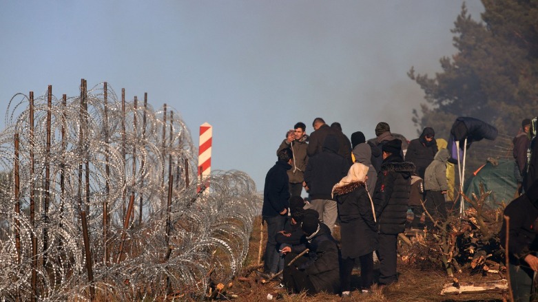 Migrants stand stranded at the Belarusian-Polish border, Nov. 9, 2021. (Photo: Leonid Shcheglov/AFP)