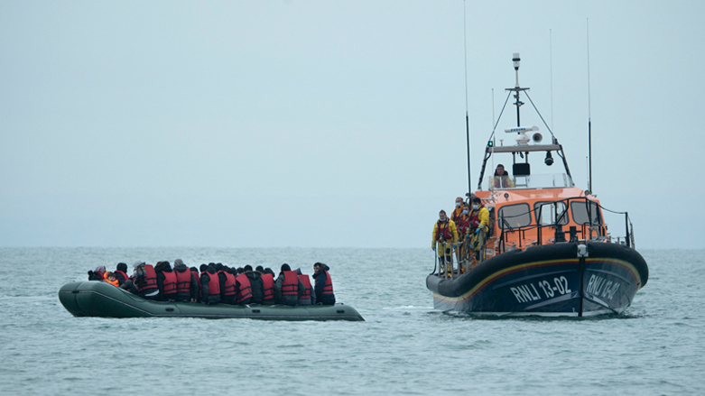 Migrants are helped by RNLI (Royal National Lifeboat Institution) lifeboat before being taken to a beach in Dungeness, on the south-east coast of England, Nov. 24, 2021. (Photo: Ben Stansall/AFP)
