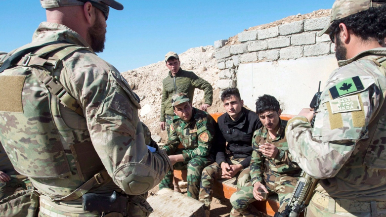 In this Feb. 20, 2017 file photo, Canadian special forces soldiers, left and right, speak with Kurdish Peshmerga fighters at an observation post, in northern Iraq. (Photo: Ryan Remiorz/The Canadian Press via AP, File)