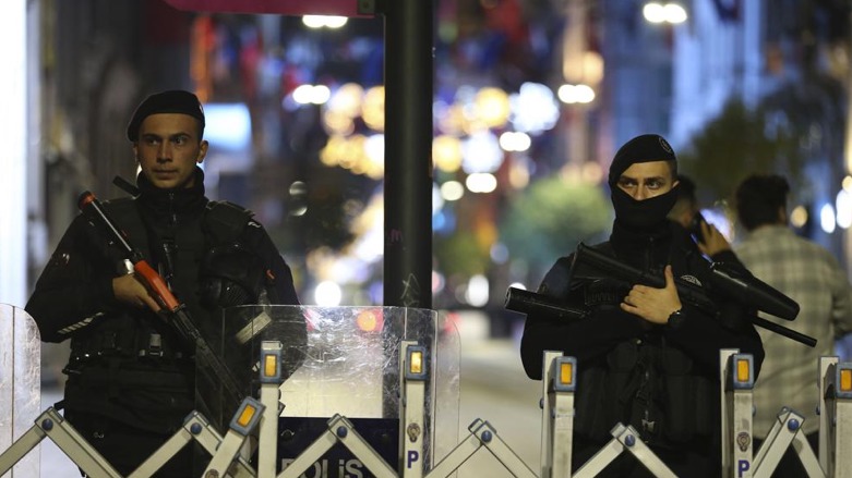 Police officers stand at the entrance the street after an explosion on Istanbul's popular pedestrian Istiklal Avenue, late Sunday, Nov. 13, 2022 (AP Photo/Emrah Gurel)