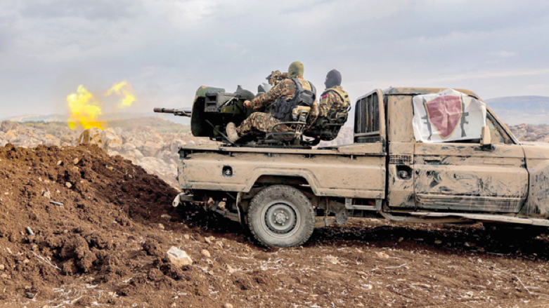 A Syrian fighter fires a turrent in the back of a 'technical' vehicle during military drills by the Turkish-backed 'Suleiman Shah Division' in the opposition-held Afrin region of northern Syria on Tuesday (Photo: AFP)