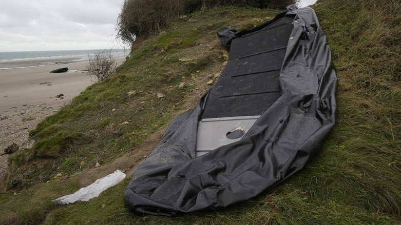 A damaged inflatable small boat is pictured on the shore in Wimereux, northern France, Thursday, Nov. 25, 2021 in Calais, northern France (Photo: AP /Michel Spingler, File)