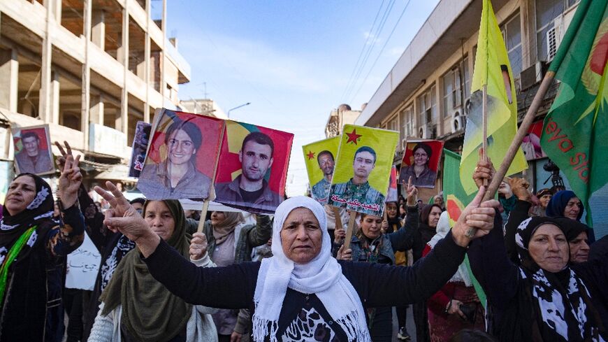 Syrian-Kurdish demonstrators raise pictures of people killed during conflict, as they protest against Turkey's threats against their region, in the northeastern Syrian Kurdish-majority city of Qamishli, on November 27, 2022. (Photo: AFP/Del