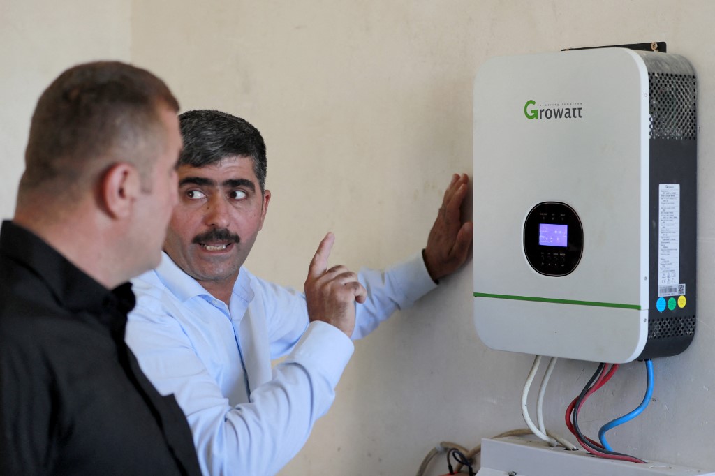 A man gives a briefing before a control panel of a battery charging system connected to solar panels in a house in the Hazer Merd village near Kurdistan Region's Sulaimani province, Sept. 19, 2023. (Photo: Ahmed Al-Rubaye/AFP)