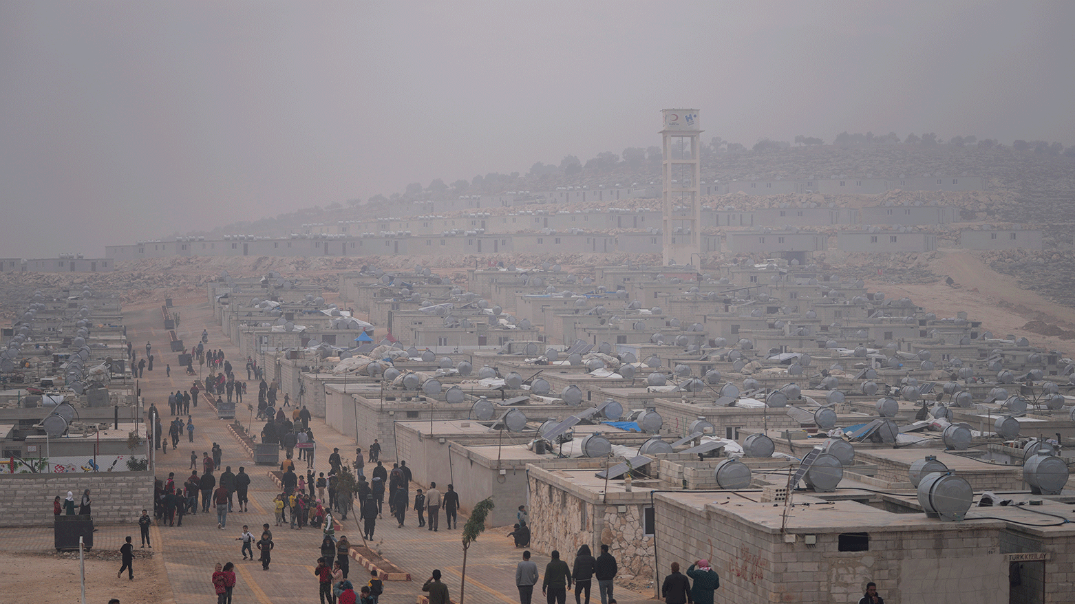 Syrians walk along in a refugee camp for displaced people run by the Turkish Red Crescent in Sarmada district, north of Idlib city, Syria, on Nov. 26, 2021. (Photo: AP)