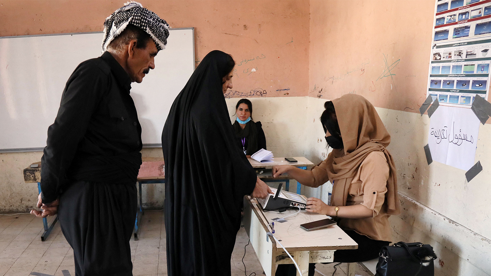 Kurdish voters register before voting in early parliamentary elections at a polling station in Kurdistan Region's Erbil, Oct. 10, 2021. (Photo: Safin Hamed/APF)