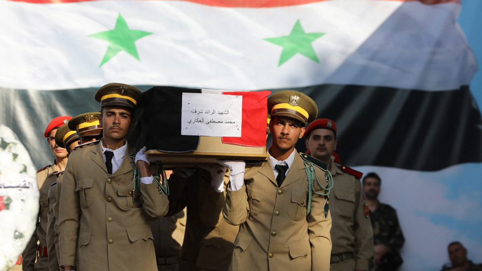 Syrian soldiers carry a casket during the funeral of the victims of a drone attack targeting a Syrian military academy, outside a hospital in government-controlled Homs, Oct. 6, 2023. (Photo: Louai Beshara/AFP)