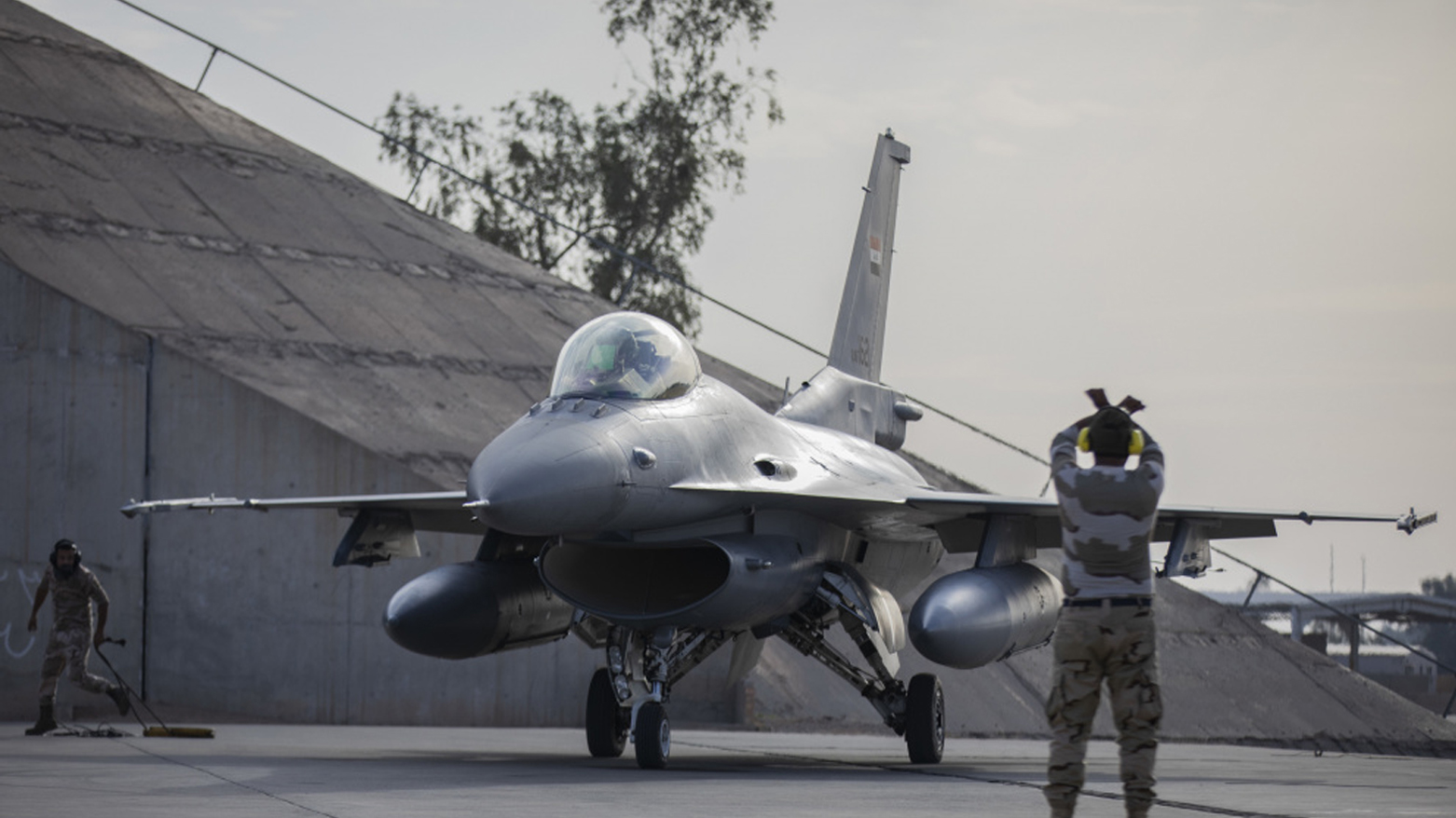 An Iraqi Air Force F-16 crew chief performs preflight checks on the aircraft before departure at Balad Air Base, Iraq, Dec. 14, 2020. (Photo: Spc. Jorge Reyes/U.S. Army Reserve)