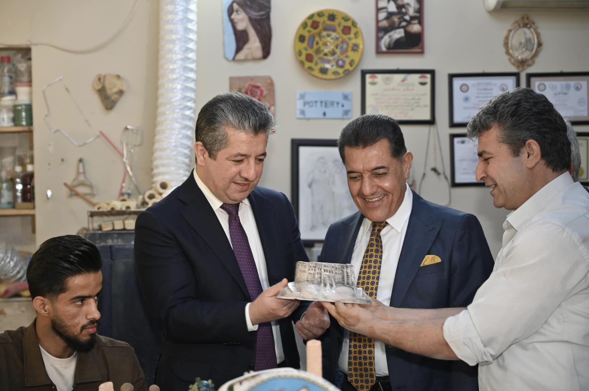 Kurdistan Region Prime Minister Masrour Barzani (right standing) reviewing arts work at festival of Fine Arts college in Erbil, Nov. 14, 2023. (Photo: KRG)