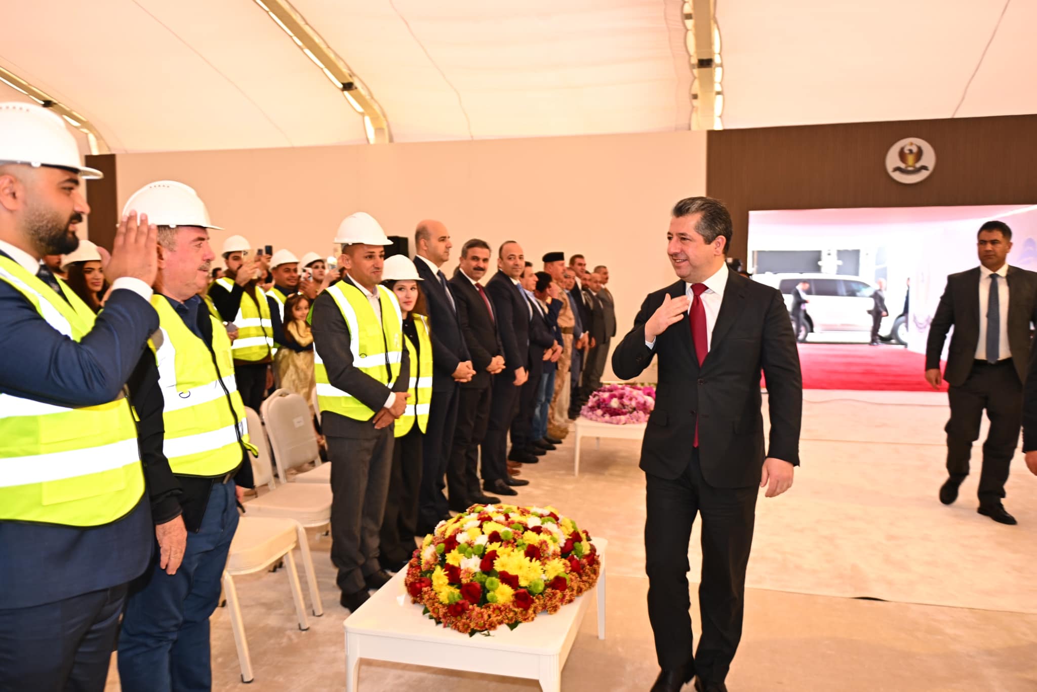 Kurdistan Region Prime Minister Masrour Barzani (right) being greeted by attendees at the laying-the-foundation-stone of Zakho Industrial Zone, recycling plant, Nov. 19, 2023. (Photo: KRG)