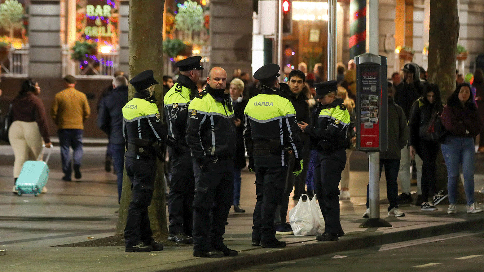 Ireland's Garda police officers stand on duty at a bus stop on O'Connell Street in Dublin on November 24, 2023. (Photo: AFP)