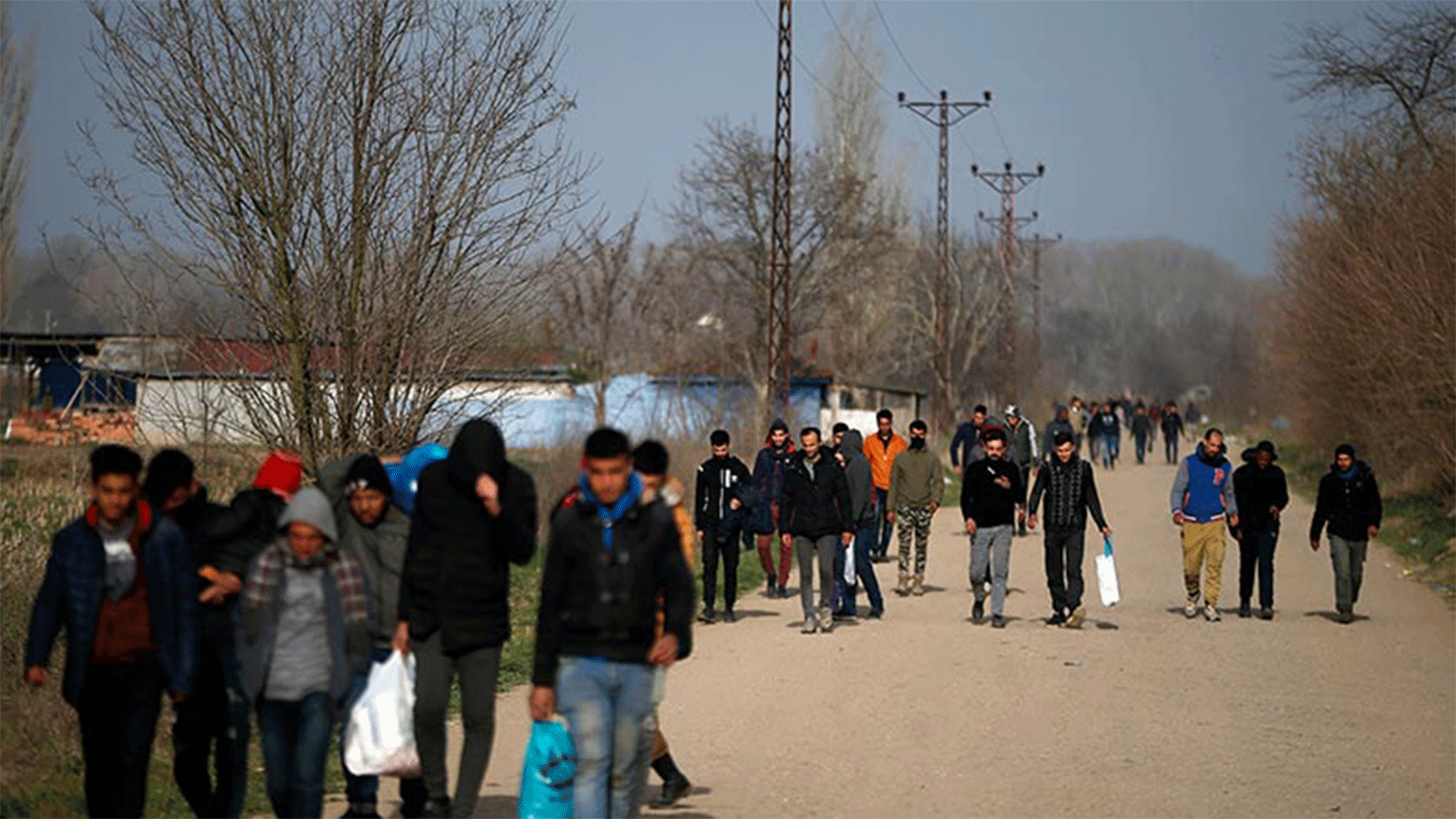 Migrants walk in Edirne at the Turkish-Greek border, March 9, 2020. (Photo: Emrah Gurel/AP)