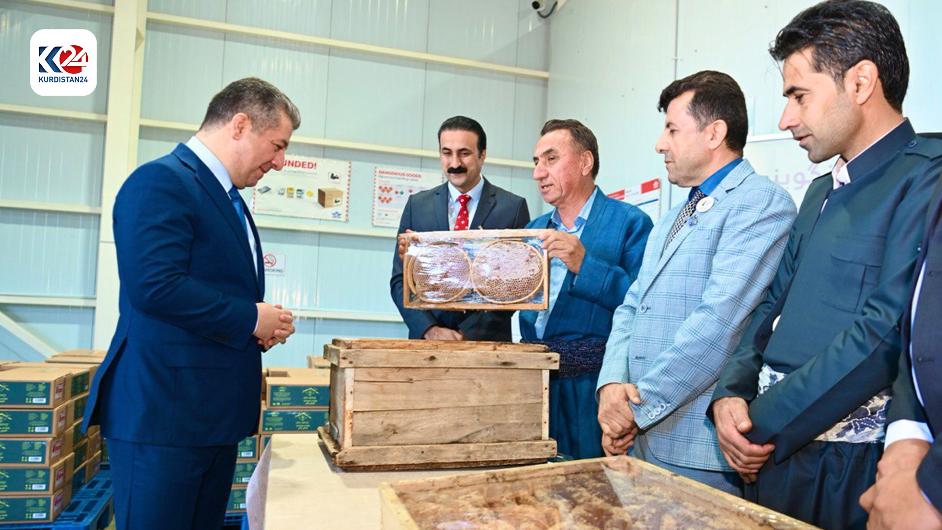 Prime Minister Masrour Barzani inspects honey produced by a local association. (Photo: KRG)