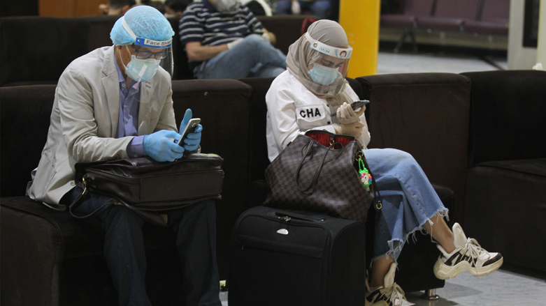 Passengers wearing protective masks wait for flights at Baghdad International Airport, July 23, 2020. (Photo: AFP/Ahmad al-Rubaye)