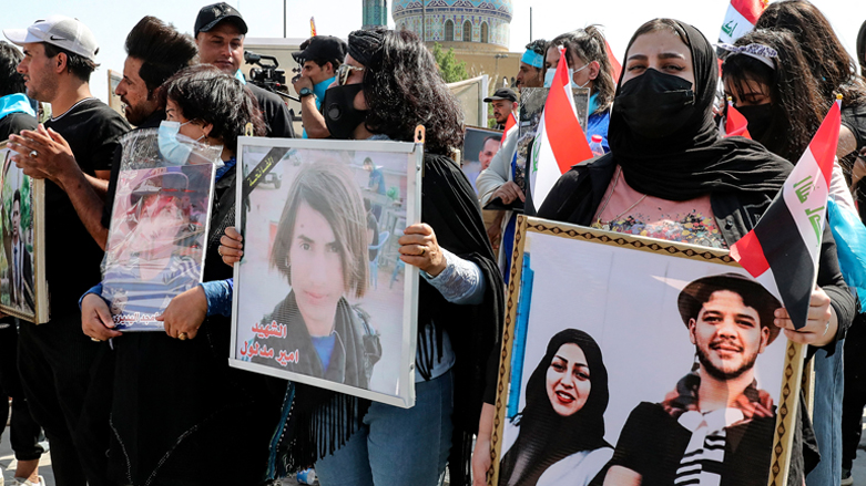 Iraqis hold pictures of demonstrators killed during the October 2020 anti-government protests, as they rally at Fardous square in central Baghdad on Friday, Oct. 1, 2021. (Photo: Sabah Arar/AFP)