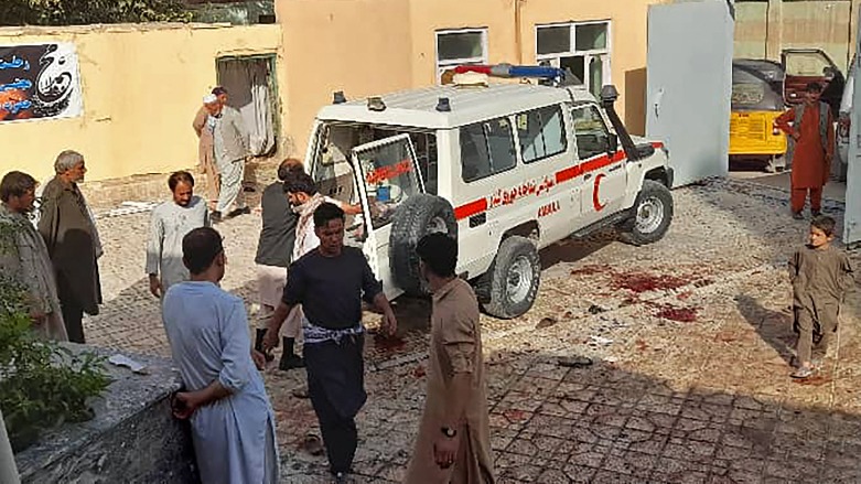 Afghan men stand next to an ambulance after a bomb attack at a mosque in Kunduz on October 8, 2021. (Photo: AFP)
