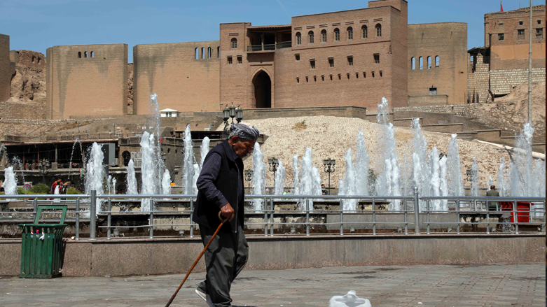 A man is seen walking with a stick in the main square around Erbil's Citadel in the capital of the Kurdistan Region, April 15, 2021. (Photo: Safin Hamed/AFP)