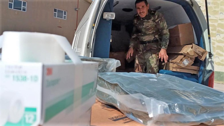A Kurdistan Region Peshmerga fighter u8nloads a shipment of medical supplies in Erbil donated by the Coalition to Defeat ISIS, Oct. 21, 2021. (Photo: Peshmerga Ministry)