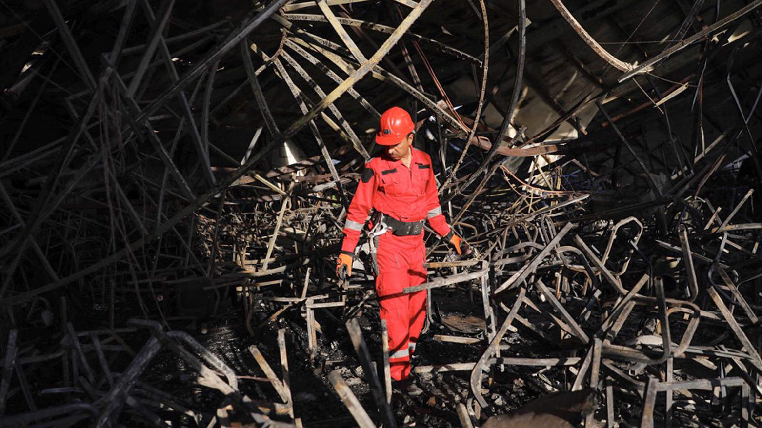 A firefighter checks the damage in an event hall in Qaraqosh, also known as Hamdaniya, after a fire broke out during a wedding, killing at least 100 people and injuring more than 150, Sept. 27, 2023. (Photo: Zaid Al-Obeidi/AFP)