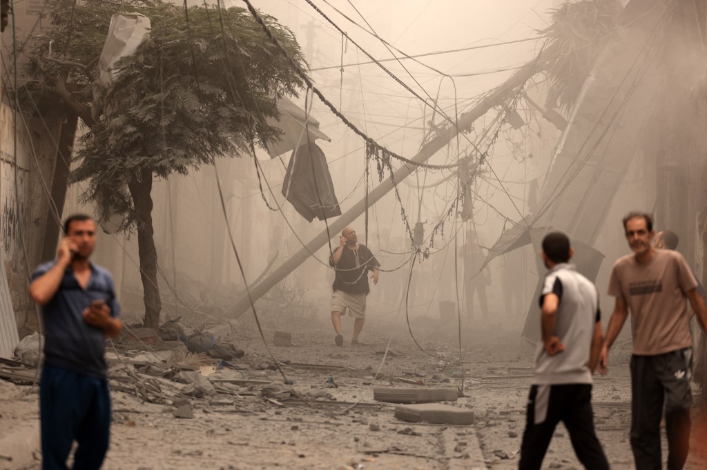 Palestinians inspect the destruction in a neighbourhood heavily damaged by Israeli airstrikes on Gaza City's Shati refugee camp early, October 9, 2023. (Photo: Mahmud Hams/AFP)