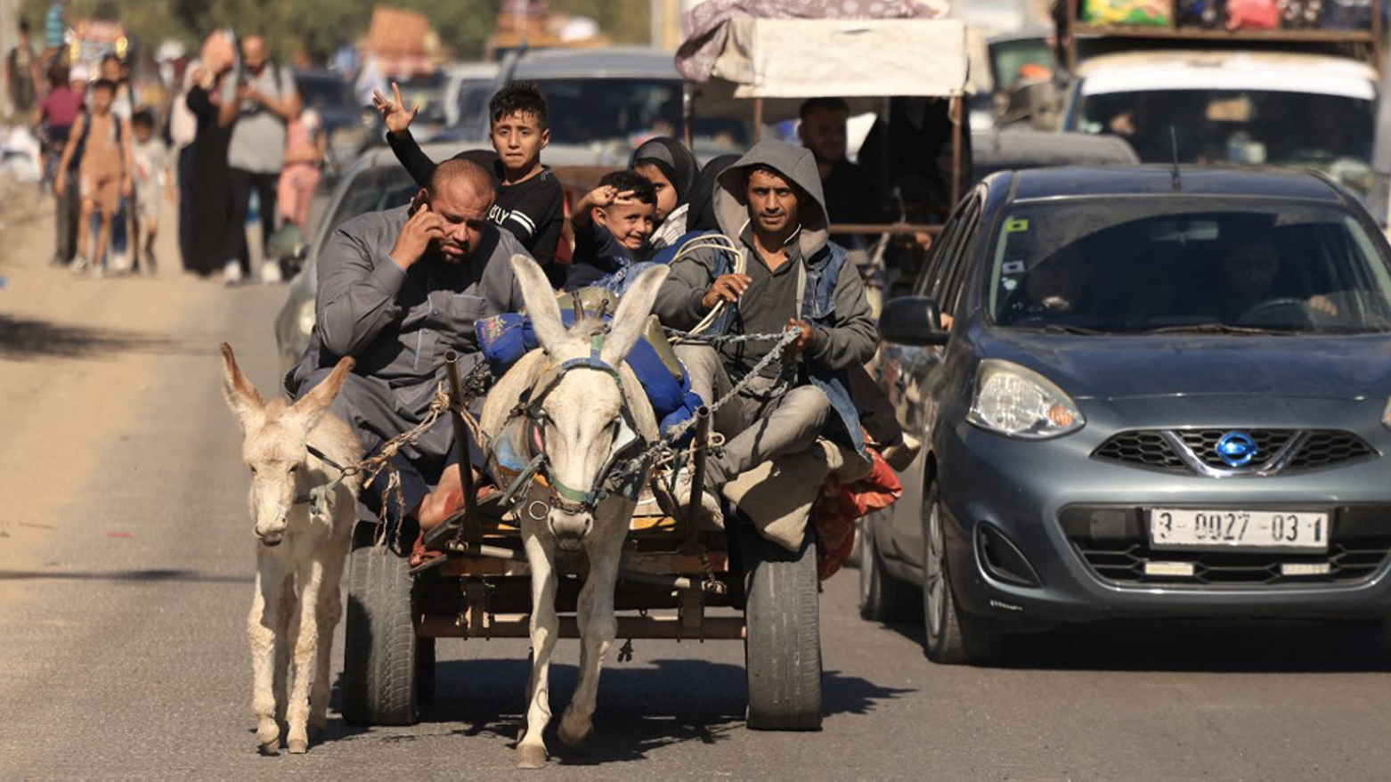 Riding a donkey drawn cart as family along with hundreds of other Palestinian flee following the Israeli army's warning to leave their homes and move south before an expected ground offensive, in Gaza City, Oct. 13, 2023. (Photo: Mahmud Ham