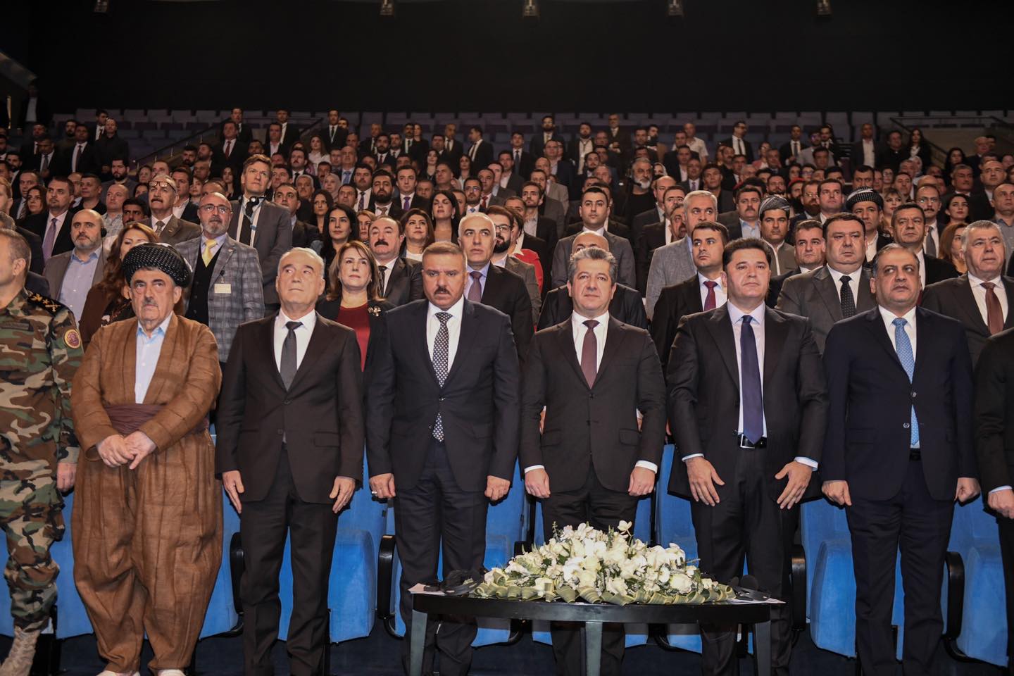 Kurdistan Region Prime Minister Masrour Barzani (center) standing for a moment of silence to honor martyrs at Conference on Combating Drugs and Psychotropic Substances, Oct. 15, 2023. (Photo: KRG)