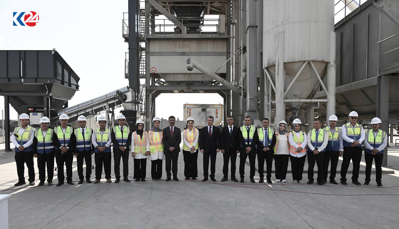 Prime Minister Masrour Barzani (middle) with employees of the asphalt plant, Oct. 17, 2023. (Photo: KRG)