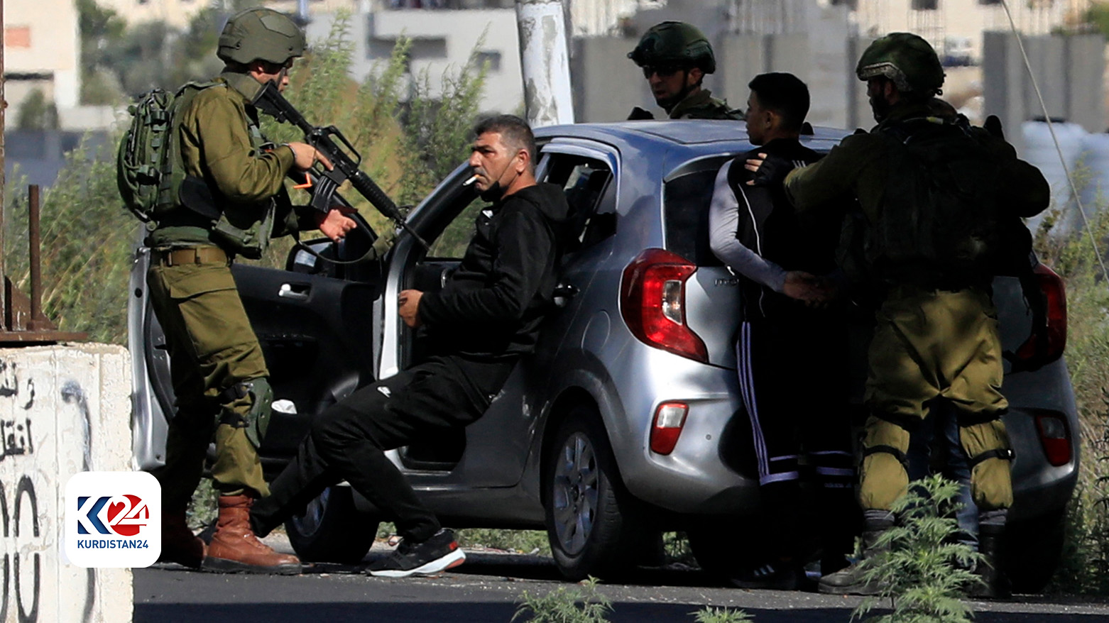 Israeli soldiers detain Palestinians after stopping their car near Huwara checkpoint, the southern entrance to Nablus city, in the occupied West Bank, Oct. 20, 2023. (Photo: Zain Jaafer/ AFP)