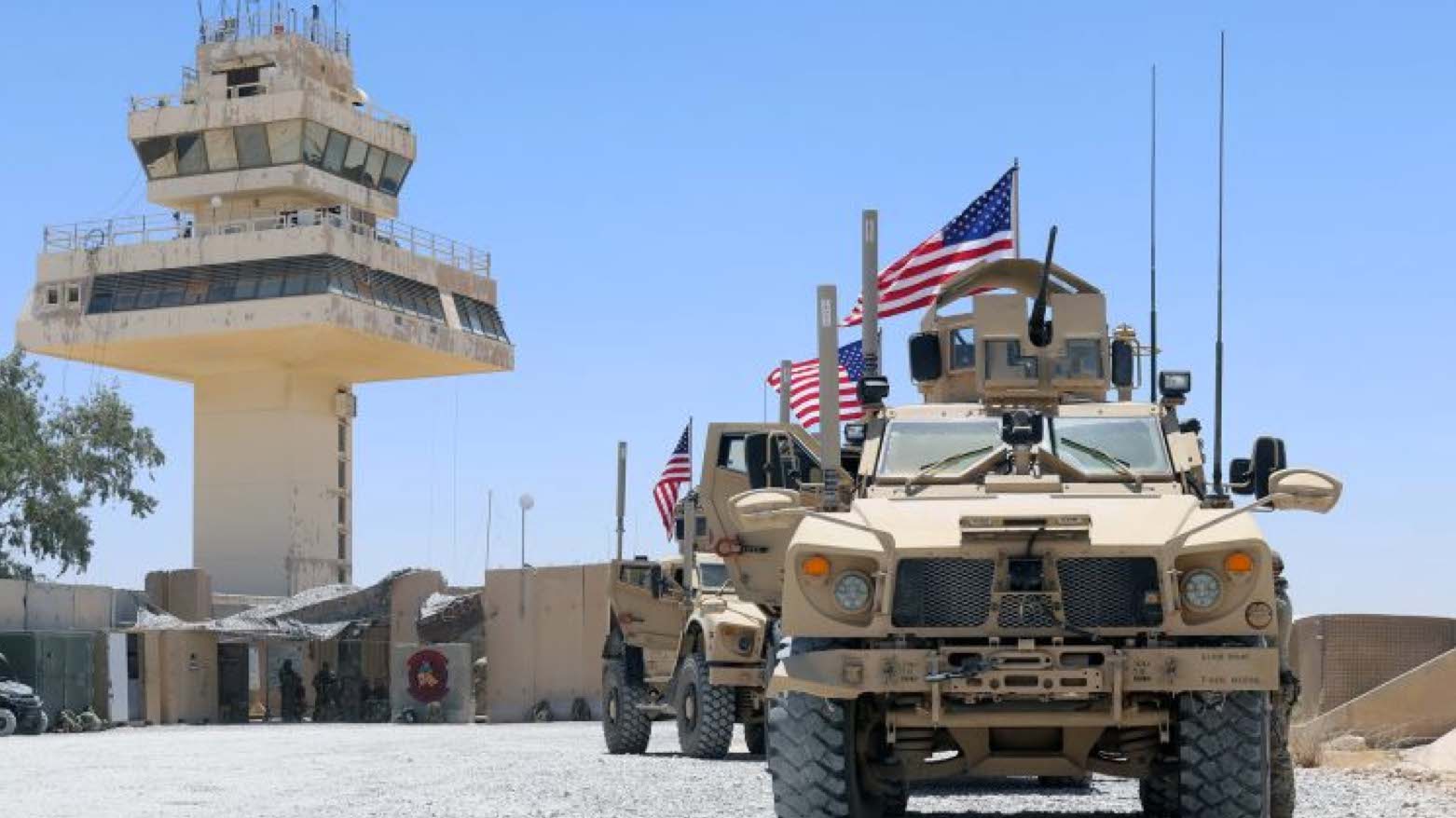 Airmen with the Security Forces Flight, 443rd Expeditionary Squadron, conduct a routine flight line patrol with U.S. flags at Al Asad Air Base on July 4, 2021. (Photo: Christie R. Smith/U.S. Army National Guard)