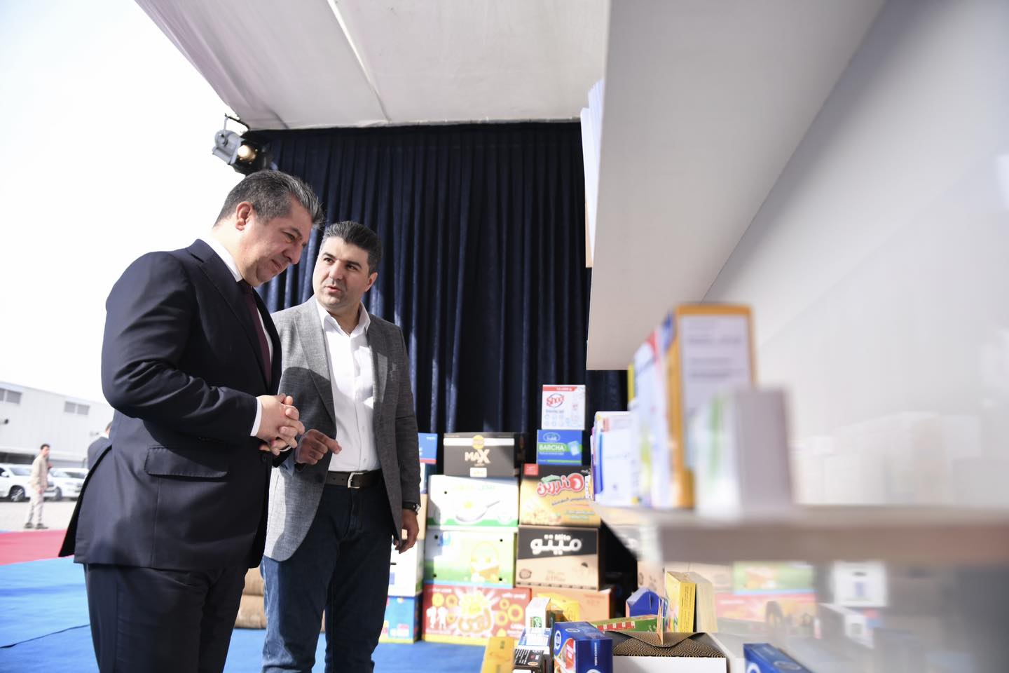 A company official presents the factory's produces to Kurdistan Region Prime Minister Masrour Barzani (left) in Erbil, Sept. 31, 2023. (Photo: KRG)