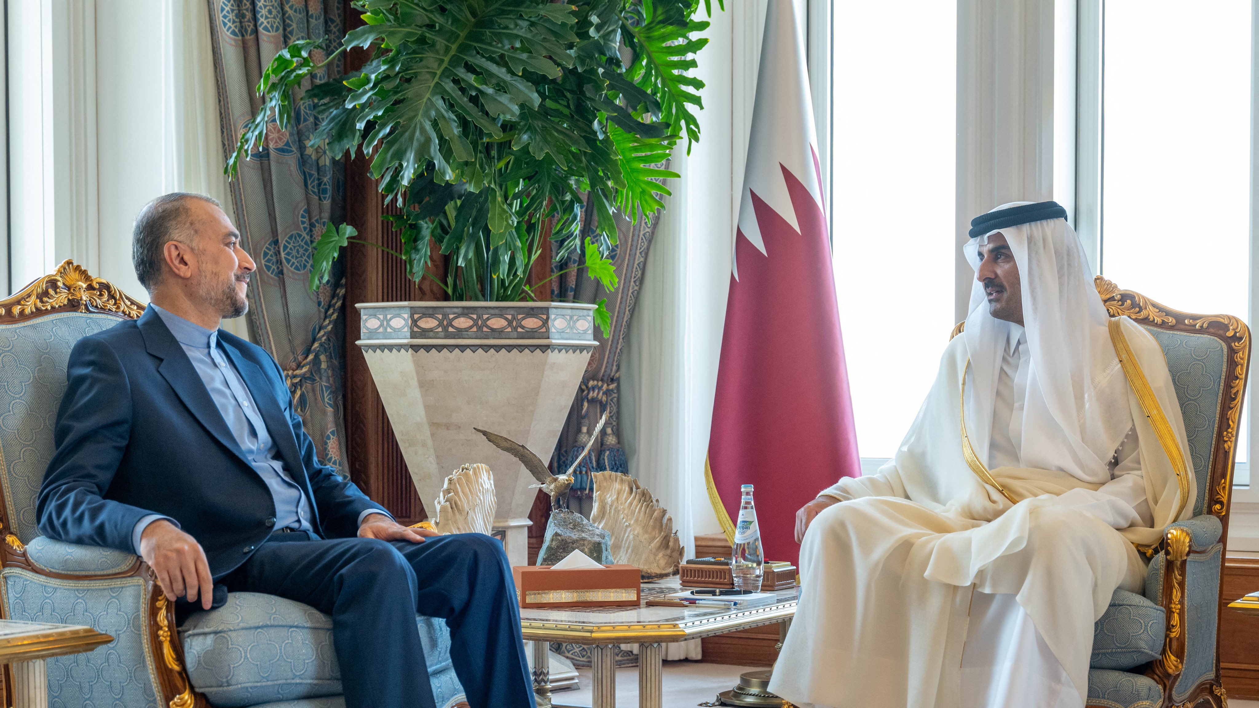 In this handout picture obtained from the official Qatar News Agency (QNA) Qatar's Emir Sheikh Tamim bin Hamad Al-Thani (R) meets with Iran's Foreign Minister Hossein Amir-Abdollahian in Doha on October 31, 2023 (QATAR NEWS AGENCY / AFP)
