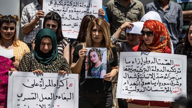 Afrin Kurds hold placards with the picture of Malik Juma'a in Qamishli, June 1, 2020. (Photo: Delil Souleiman, AFP)
