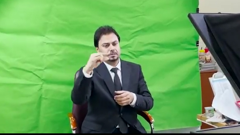A sign language interpreter is pictured recording an explanatory video on Iraqi elections to deaf community. (Photo: Screengrab from a UNAMI video)