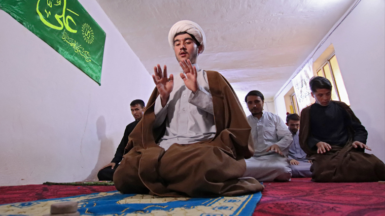 Afghans, from the Hazara ethnic minority studying at the prestigious "hawza" seminary that trains Shiite clergy, pray in their room in the holy city of Najaf, Aug. 29, 2021. (Photo: Ali Najafi/AFP)