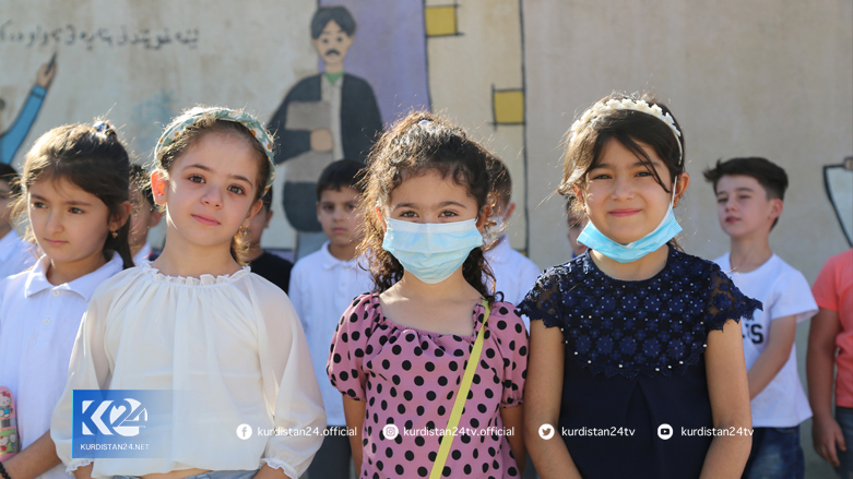 Three female pupils pose for a photo at their school yard in Sulaimani province on first day of school, Sept. 14, 2021. (Photo: Dana Hama Gharib/Kurdistan 24)