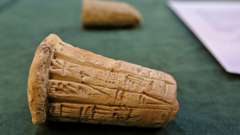 Mesopotamian clay cones bearing cuneiform inscriptions are displayed during a handover ceremony of a trove of looted Iraqi antiquities returned by the United States, August 3, 2021. (Photo: Sabah Arar/AFP)