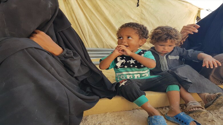 Children sit next to their mother in al-Hol camp, July 9, 2019 (Photo: Wladimir van Wilgenburg/Kurdistan 24)