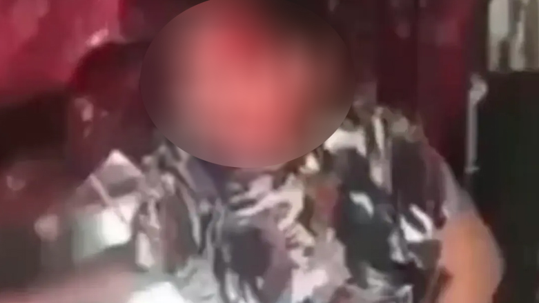 A blurred still from a video appearing to show the abuse of an Iraqi child. (Photo: Social Media)